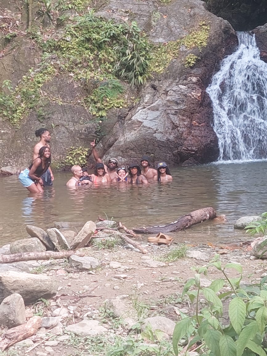 Clients having fun at the Top River Falls in Parlatuvier, Tobago